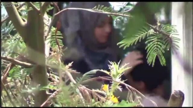 Indonesian muslim slut in hijab boobs pressed sucked riding cock of her boyfriend in public park amateur outdoor voyeur caught